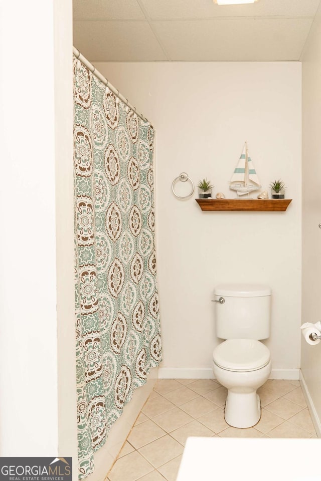 17 Hampton Way, Carrollton, GA 30116 - bathroom featuring toilet, curtained shower, tile patterned flooring, and baseboards