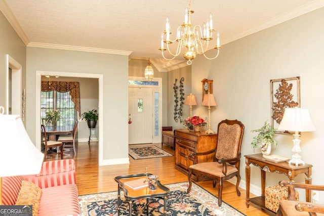17 Hampton Way, Carrollton, GA 30116 - living room featuring crown molding, a chandelier, and light wood-type flooring