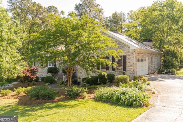 17 Hampton Way, Carrollton, GA 30116 - obstructed view of property featuring a chimney, brick siding, an attached garage, a front yard, and aphalt driveway