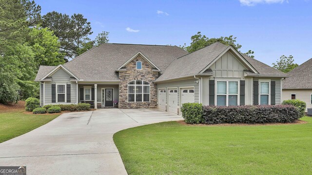 80 Kenwood Trl, Senoia, GA 30276 - ranch-style home with board and batten siding, a garage, concrete driveway, stone siding, and a front lawn