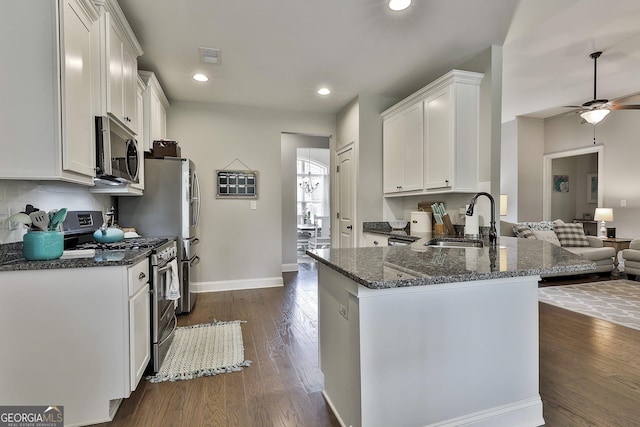 80 Kenwood Trl, Senoia, GA 30276 - kitchen featuring a sink, dark stone counters, ceiling fan, white cabinets, and appliances with stainless steel finishes