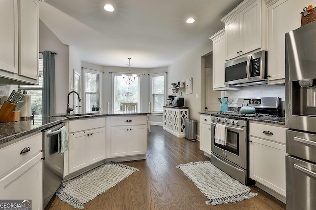 80 Kenwood Trl, Senoia, GA 30276 - kitchen featuring a peninsula, appliances with stainless steel finishes, dark wood-style flooring, and a sink
