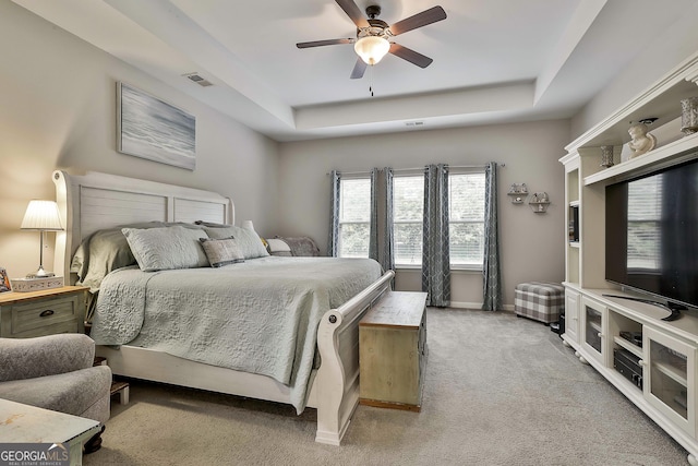 80 Kenwood Trl, Senoia, GA 30276 - bedroom featuring light colored carpet, visible vents, a ceiling fan, a raised ceiling, and baseboards