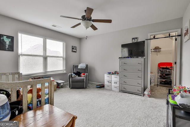 80 Kenwood Trl, Senoia, GA 30276 - bedroom with visible vents, a ceiling fan, a spacious closet, and carpet floors