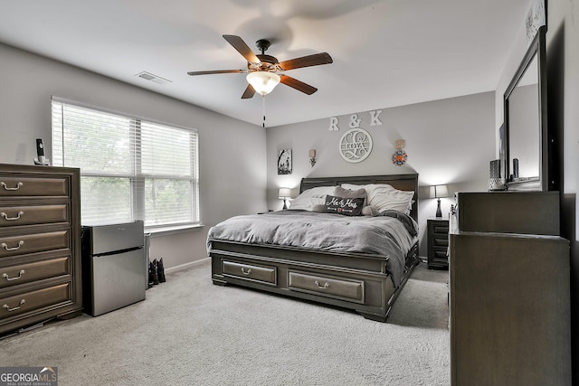 80 Kenwood Trl, Senoia, GA 30276 - bedroom with freestanding refrigerator, baseboards, ceiling fan, visible vents, and light carpet
