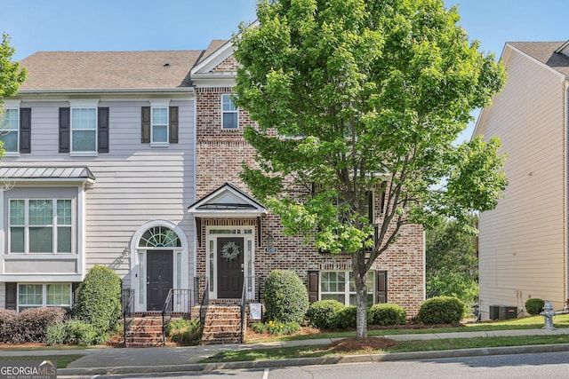 1257 Park Pass Way, Suwanee, GA 30024 - townhome / multi-family property with roof with shingles, cooling unit, and brick siding