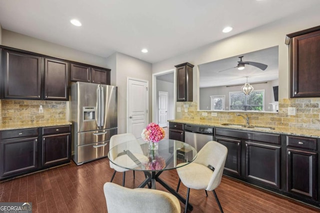 1257 Park Pass Way, Suwanee, GA 30024 - kitchen with decorative backsplash, appliances with stainless steel finishes, a sink, and dark brown cabinetry