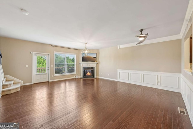 1257 Park Pass Way, Suwanee, GA 30024 - unfurnished living room with hardwood / wood-style flooring, stairs, a glass covered fireplace, and visible vents