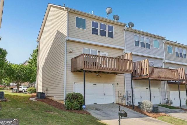 1257 Park Pass Way, Suwanee, GA 30024 - back of property with central air condition unit, a lawn, an attached garage, and driveway