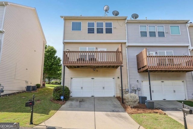 1257 Park Pass Way, Suwanee, GA 30024 - rear view of house with a yard, driveway, a balcony, an attached garage, and central AC unit
