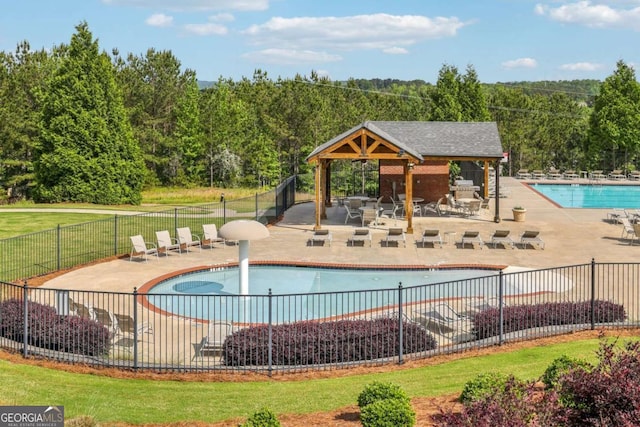 1257 Park Pass Way, Suwanee, GA 30024 - community pool with a gazebo, a patio area, a forest view, and fence