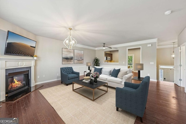 1257 Park Pass Way, Suwanee, GA 30024 - living room with baseboards, a glass covered fireplace, ceiling fan, crown molding, and wood finished floors
