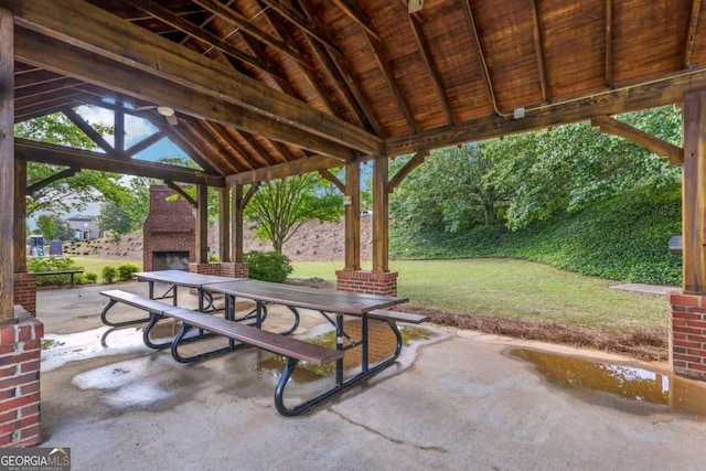 1257 Park Pass Way, Suwanee, GA 30024 - view of patio featuring a gazebo, an outdoor brick fireplace, and outdoor dining space