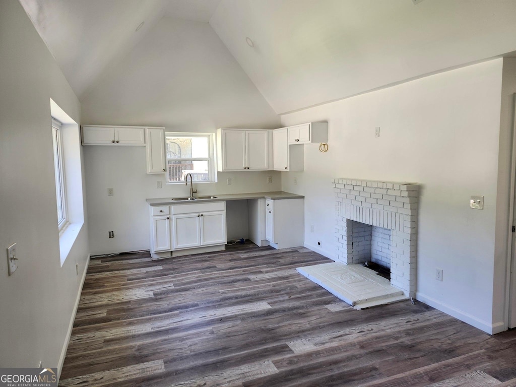 2040 Chicago Ave NW, Atlanta, GA 30314 - kitchen featuring a sink, white cabinetry, dark wood-style floors, high vaulted ceiling, and baseboards