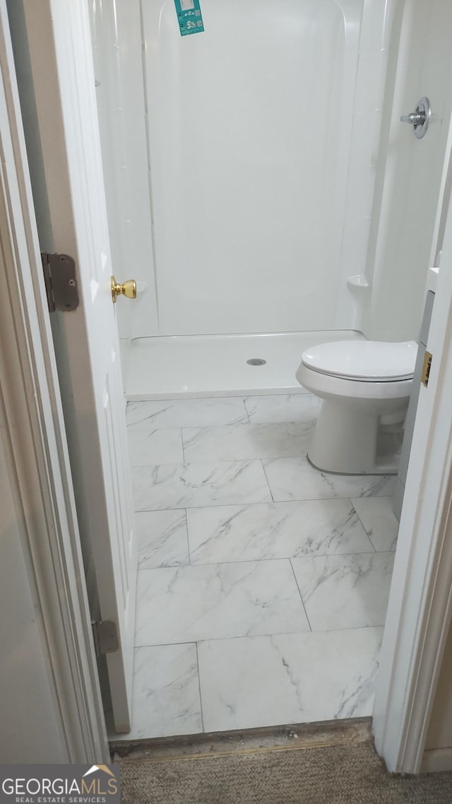 full bath with toilet, marble finish floor, and walk in shower