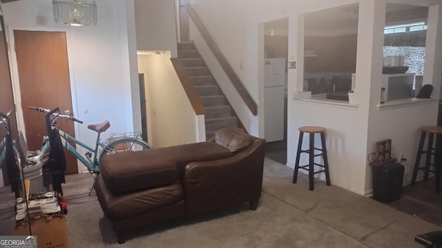 carpeted living room featuring stairway