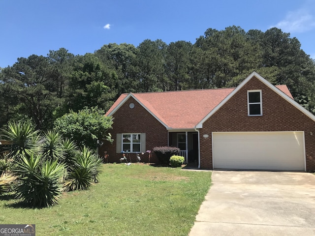 view of front facade featuring concrete driveway, an attached garage, a front lawn, and brick siding