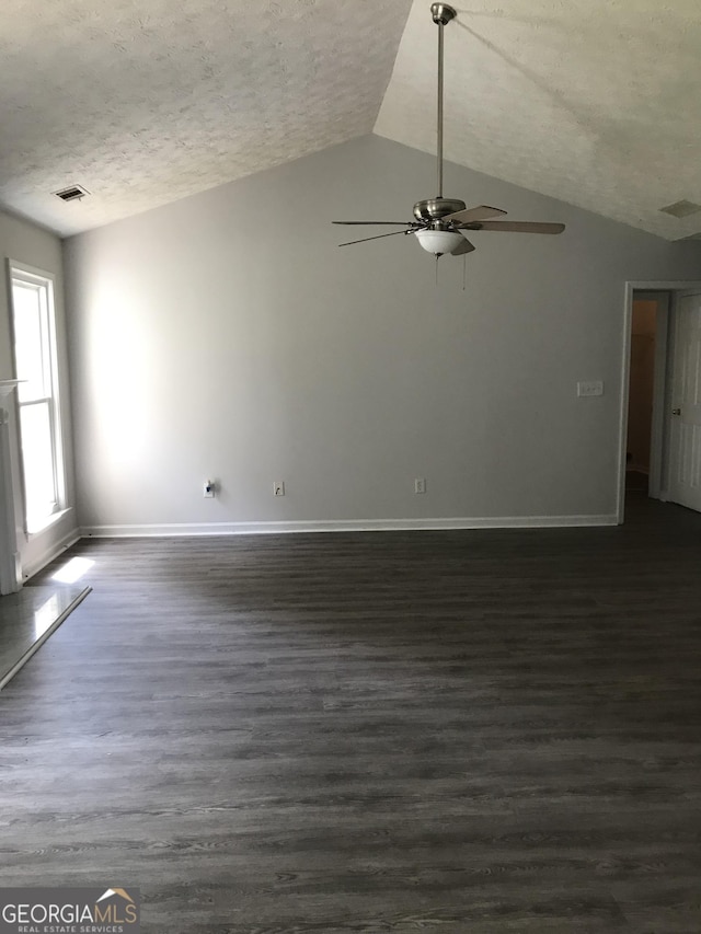 unfurnished living room with a textured ceiling, vaulted ceiling, baseboards, and a ceiling fan