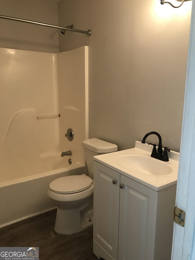 full bath featuring vanity, toilet, tub / shower combination, and wood finished floors