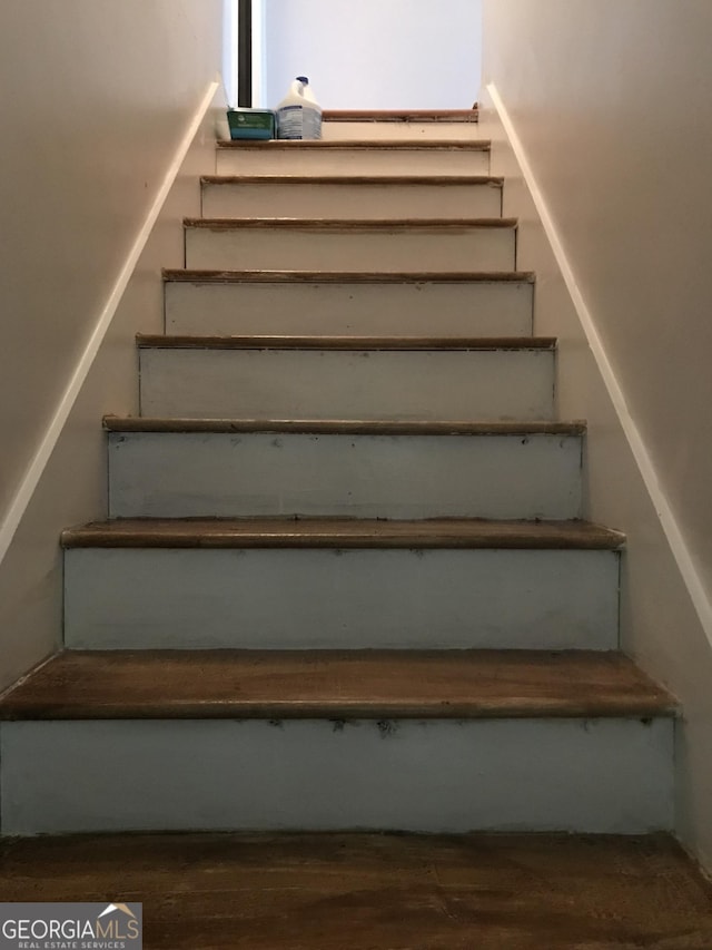 stairway featuring wood finished floors