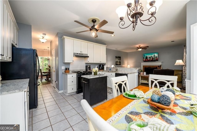 2759 Beddington Way, Suwanee, GA 30024 - kitchen with black appliances, a ceiling fan, light tile patterned floors, under cabinet range hood, and open floor plan