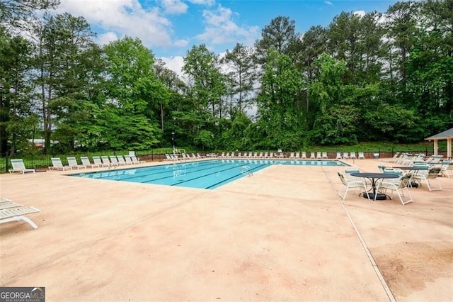 2759 Beddington Way, Suwanee, GA 30024 - community pool featuring a patio area and view of scattered trees