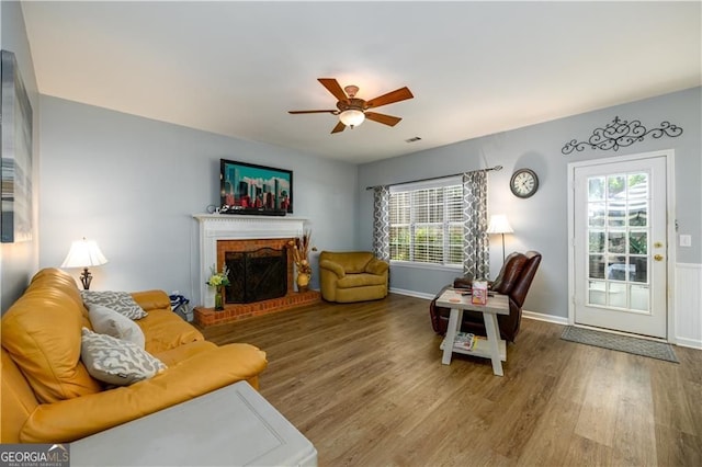 2759 Beddington Way, Suwanee, GA 30024 - living area with plenty of natural light, wood finished floors, a ceiling fan, and a brick fireplace