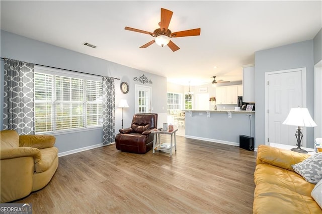 2759 Beddington Way, Suwanee, GA 30024 - living room featuring ceiling fan, wood finished floors, and baseboards