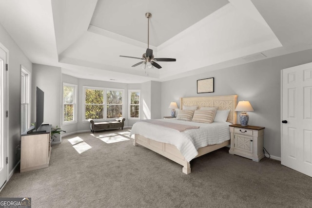 3498 Westhampton Way, Gainesville, GA 30506 - carpeted bedroom featuring a tray ceiling, baseboards, and a ceiling fan