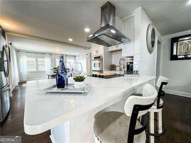 2638 Cleburne Pkwy, Powder Springs, GA 30127 - kitchen with a sink, stainless steel appliances, island range hood, dark wood-type flooring, and baseboards