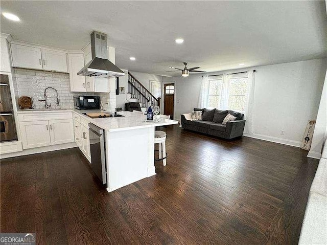 2638 Cleburne Pkwy, Powder Springs, GA 30127 - kitchen featuring a peninsula, a sink, wall chimney exhaust hood, ceiling fan, and dishwasher