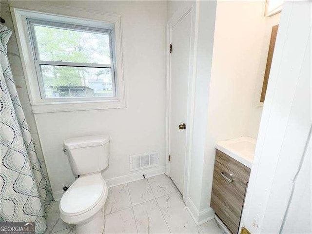 2638 Cleburne Pkwy, Powder Springs, GA 30127 - bathroom featuring toilet, visible vents, marble finish floor, and baseboards