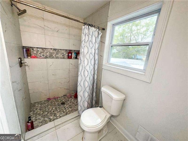 2638 Cleburne Pkwy, Powder Springs, GA 30127 - bathroom featuring toilet, visible vents, tile patterned floors, baseboards, and tiled shower