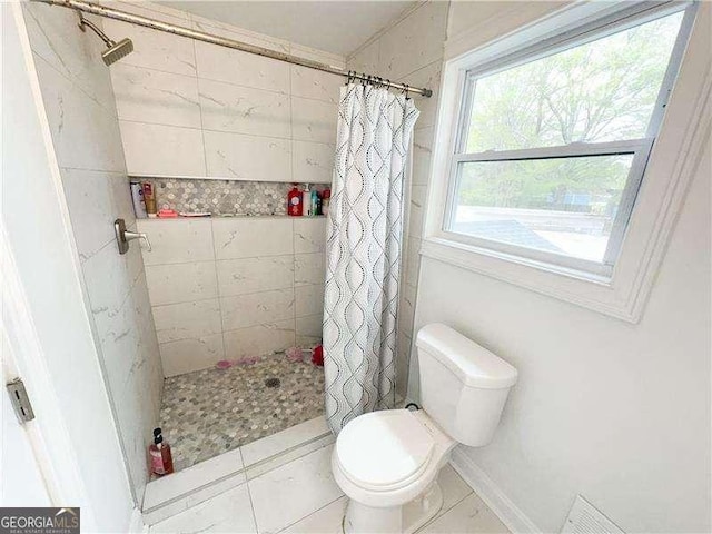 2638 Cleburne Pkwy, Powder Springs, GA 30127 - full bath with a tile shower, tile patterned flooring, and toilet