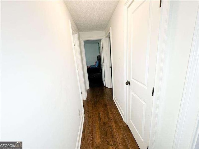 2638 Cleburne Pkwy, Powder Springs, GA 30127 - hall with dark wood finished floors, a textured ceiling, and baseboards