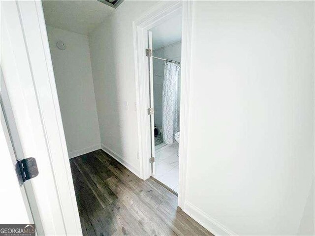 2638 Cleburne Pkwy, Powder Springs, GA 30127 - corridor with baseboards and dark wood-type flooring