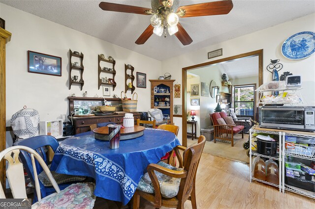 4720 Bill Cheek Rd, Auburn, GA 30011 - dining space featuring a ceiling fan, a toaster, visible vents, and wood finished floors