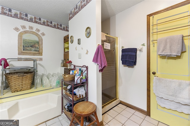 4720 Bill Cheek Rd, Auburn, GA 30011 - full bath featuring tile patterned floors, a textured ceiling, and a shower stall