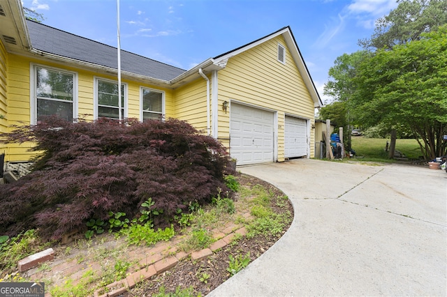 4720 Bill Cheek Rd, Auburn, GA 30011 - view of side of home featuring driveway and a garage