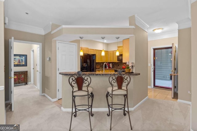 kitchen with black appliances, crown molding, light carpet, decorative backsplash, and a peninsula