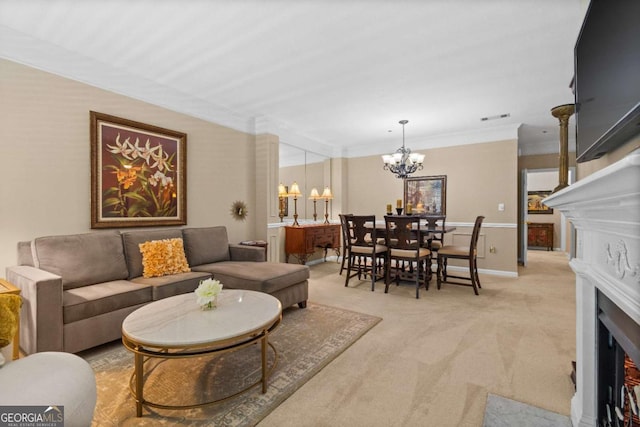 living room with light colored carpet, a chandelier, ornamental molding, and a fireplace with flush hearth