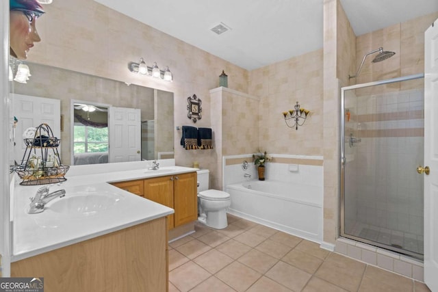 full bathroom with tile patterned floors, a shower stall, double vanity, and a garden tub