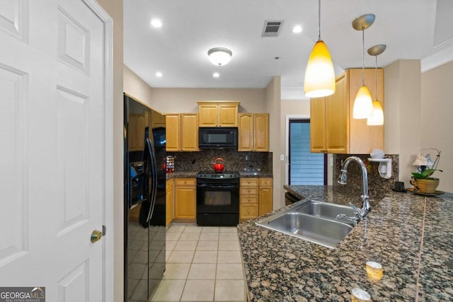 kitchen with black appliances, a sink, tasteful backsplash, light tile patterned flooring, and decorative light fixtures