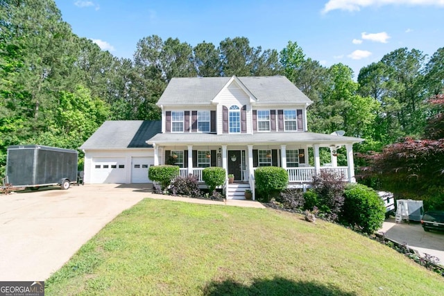 colonial-style house with a porch, concrete driveway, a garage, and a front yard