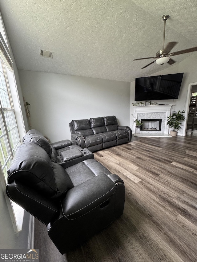 85 Creekside Trl, Covington, GA 30016 - living area featuring ceiling fan, wood finished floors, a textured ceiling, and a fireplace