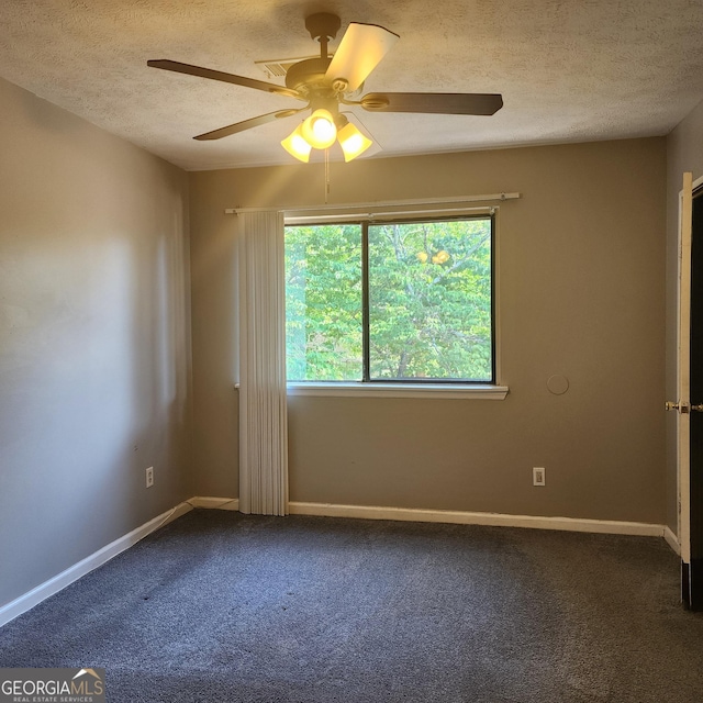 unfurnished room with carpet flooring, a textured ceiling, baseboards, and a ceiling fan
