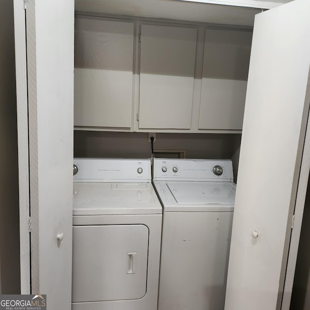 washroom with cabinet space and independent washer and dryer