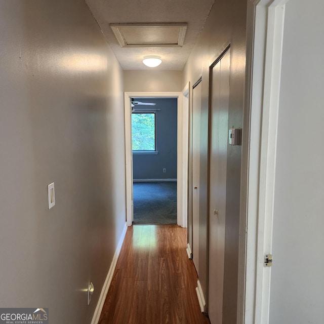 hall with baseboards and dark wood finished floors