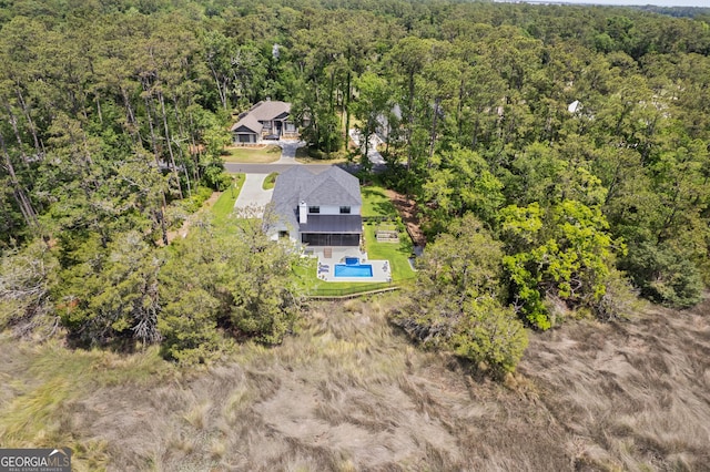 birds eye view of property with a view of trees