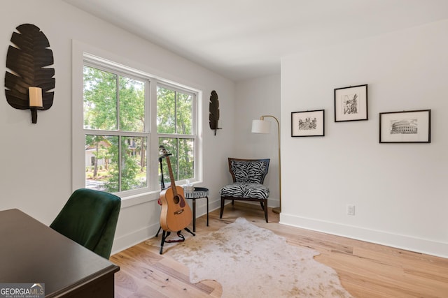 office area featuring light wood finished floors and baseboards